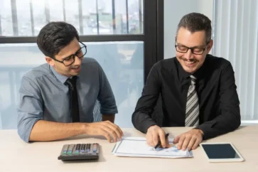 jolly-business-partners-discussing-sales-development-meeting-1.jpg